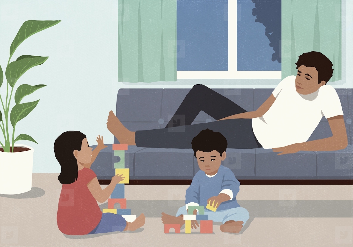 Father laying on sofa relaxing and watching kids playing with toy blocks