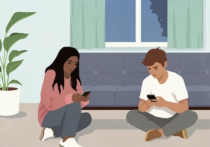 Multiracial couple using smart phones at living room sofa Multiracial couple using smart phones at living room sofa