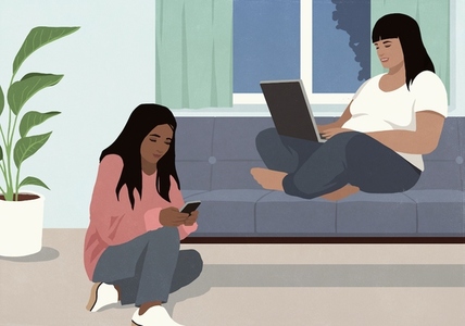 Multiracial women working at laptop and using smart phone at living room Multiracial women working at laptop and using smart phone at living room