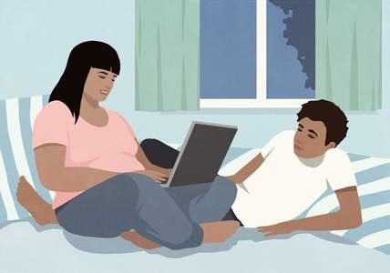 Couple relaxing at home on bed using laptop at night Couple relaxing at home on bed using laptop at night