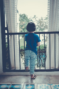 Boy Looking Out Window