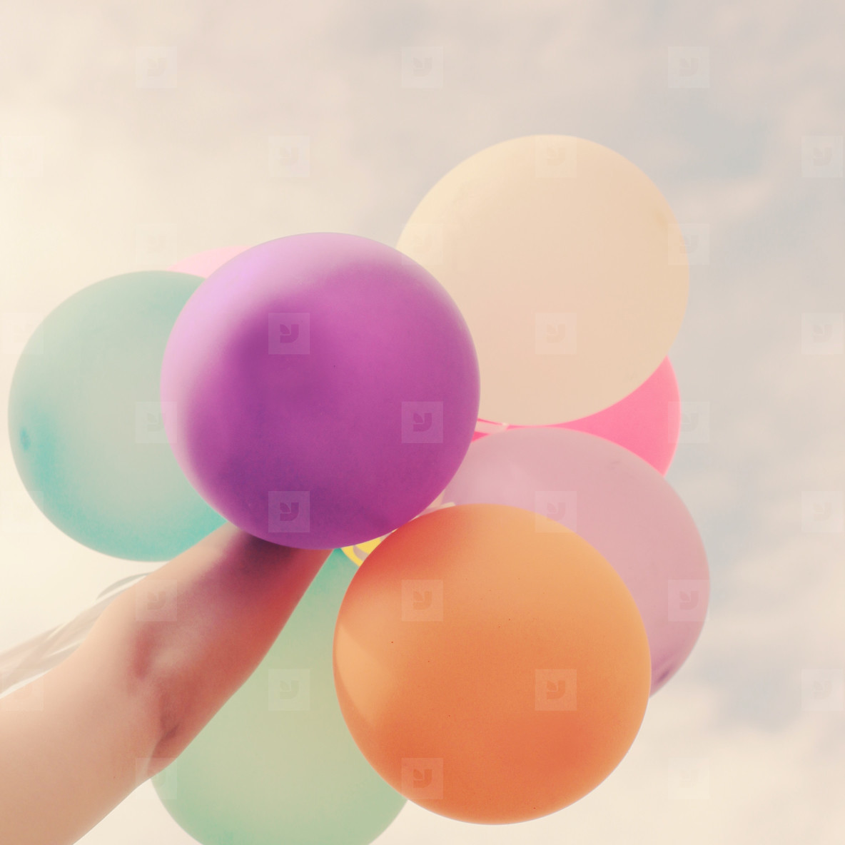 Hand holding balloons
