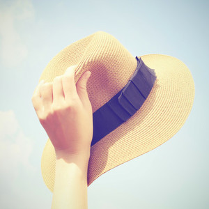 Woman hand holding panama hat