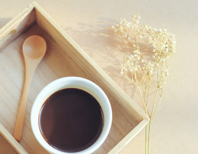 Black coffee and spoon on tray