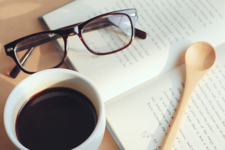 eyeglasses and book with coffee