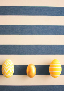 Yellow easter eggs on striped