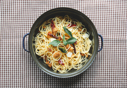 Homemade spaghetti on tablecloth