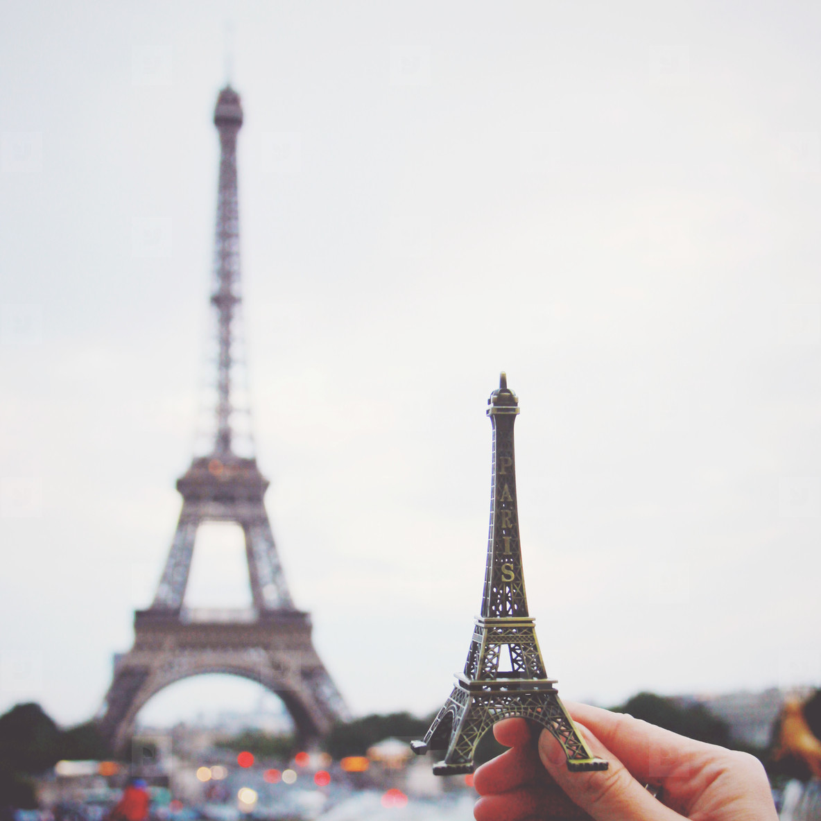 Hand holding eiffel tower model