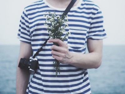 Young man holding flowers