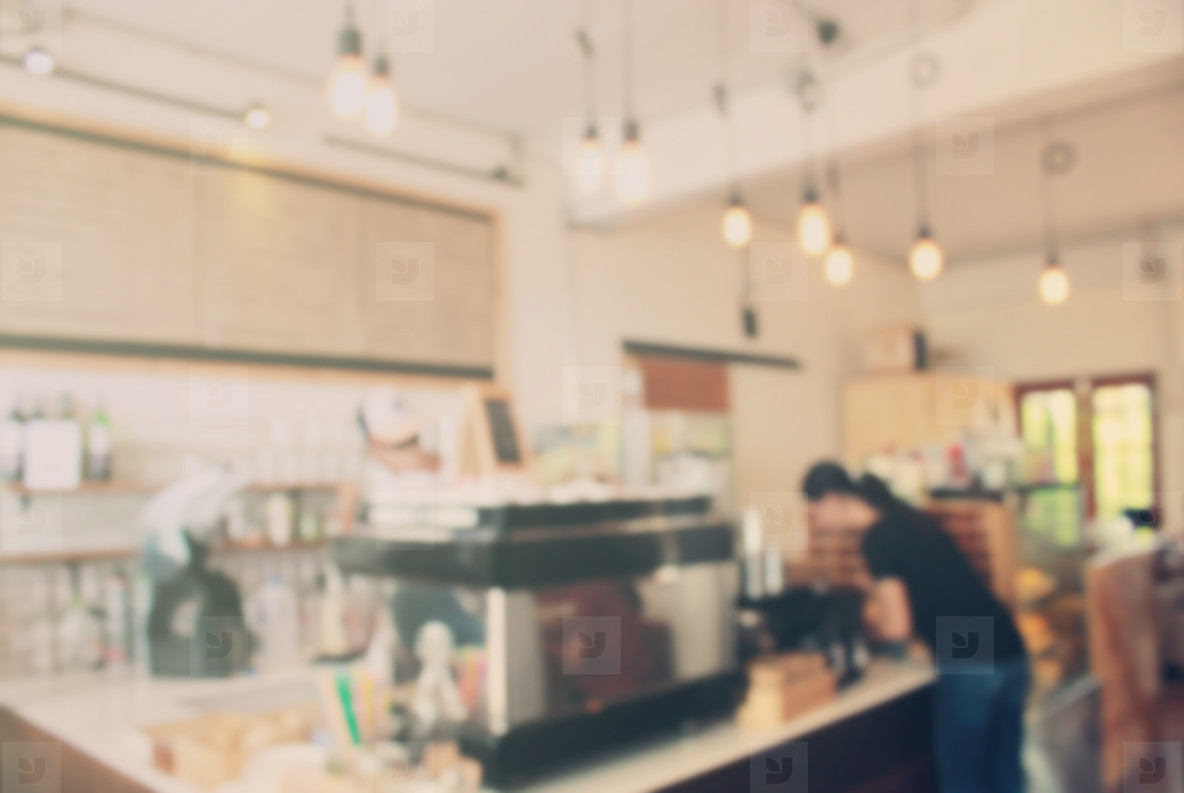Barista at cafe blur background