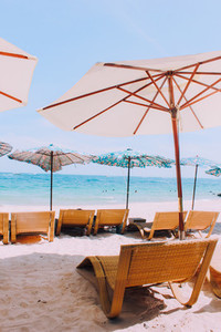 Beach chair and umbrella on sand