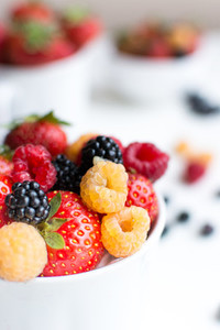 Closeup Berries in cups on white