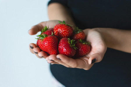 Strawberries in hands isolated