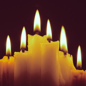 Burning candles on black