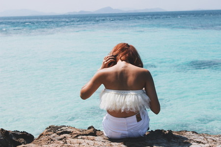 Back view of young girl on ocean