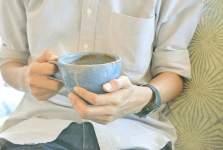 Blue Cup of coffee in hands
