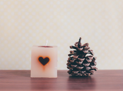 candle and pine cone