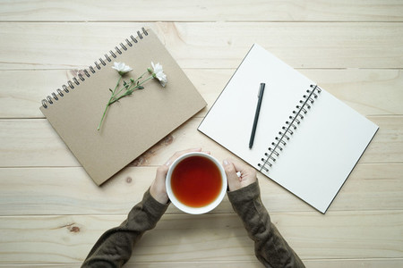 cup of tea and opened notebook