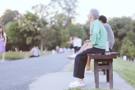 Grandparent seated on a bench