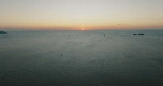 Sunset Over The Ocean With Boats