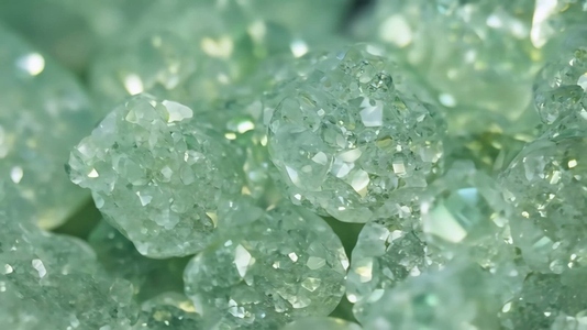 Close up of sparkling green prehnite crystals with a textured