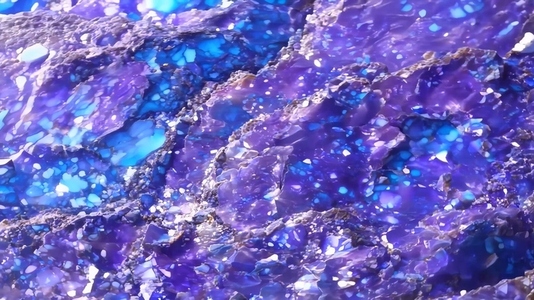 Close up of a vibrant blue and purple Sodalite gemstone texture