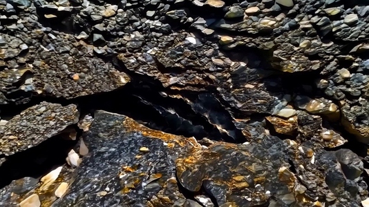 A close up view of textured rock formations with dark and light