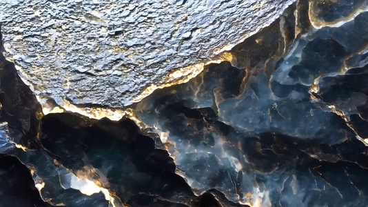 A close up view of textured rock formations with shiny