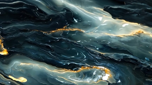 An abstract close up of swirling dark blue and green marble