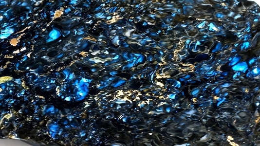 A close up view of shimmering water with vibrant blue and black