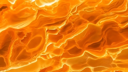 A close up view of a vibrant orange and yellow abstract texture