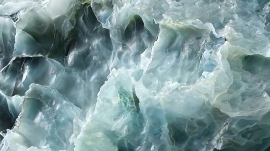A close up view of textured translucent blue green mineral