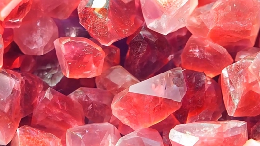 Close up of various pink and red Strawberry Quartz crystals