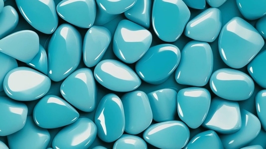 A close up view of smooth  glossy turquoise pebbles arranged