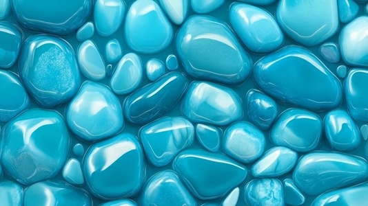 Smooth glossy turquoise pebbles arranged closely together