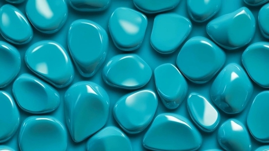 Smooth glossy turquoise pebbles arranged randomly on a surface
