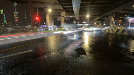 Nighttime timelapse urban scene with light trails under a highwa