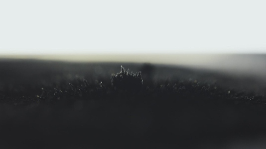 Macro View of Volcanic Sand Reacting To Magnetic Attraction