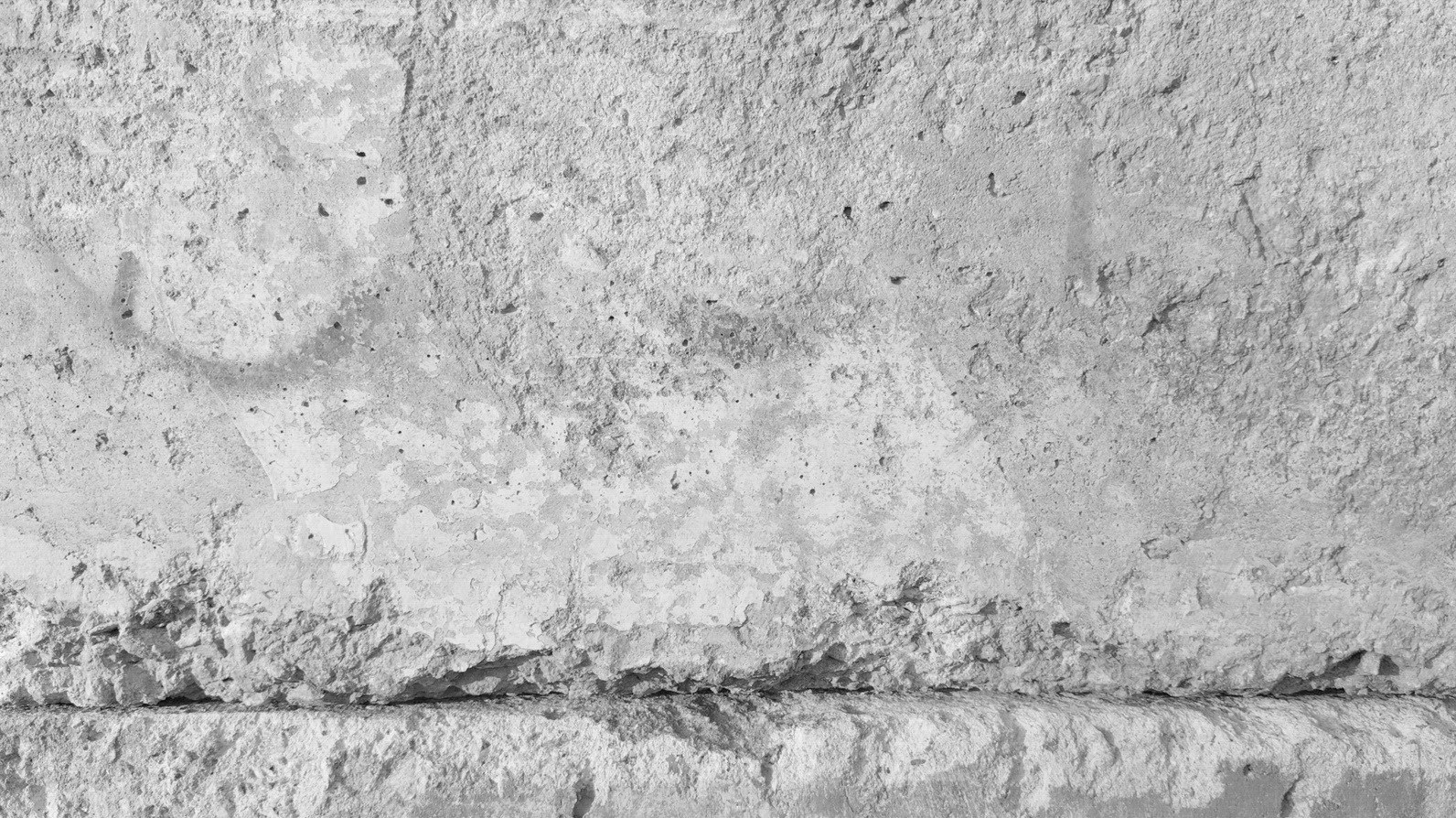 A textured concrete wall background with rough surfaces