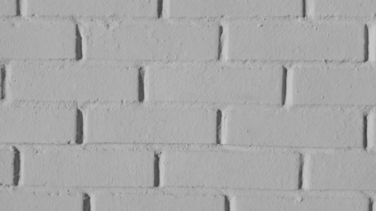 A close up view of a textured gray brick wall background