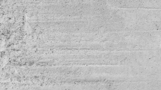 A close up view of a textured concrete wall background