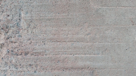 A textured concrete surface with subtle variations in color