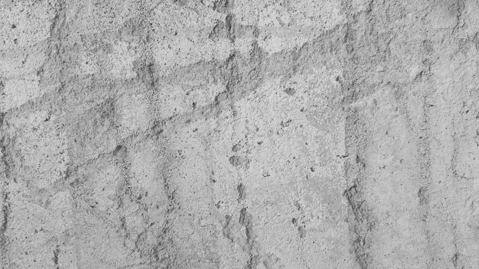 A textured gray concrete wall background with visible patterns