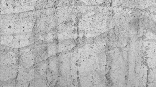 A textured concrete wall background with visible scratches