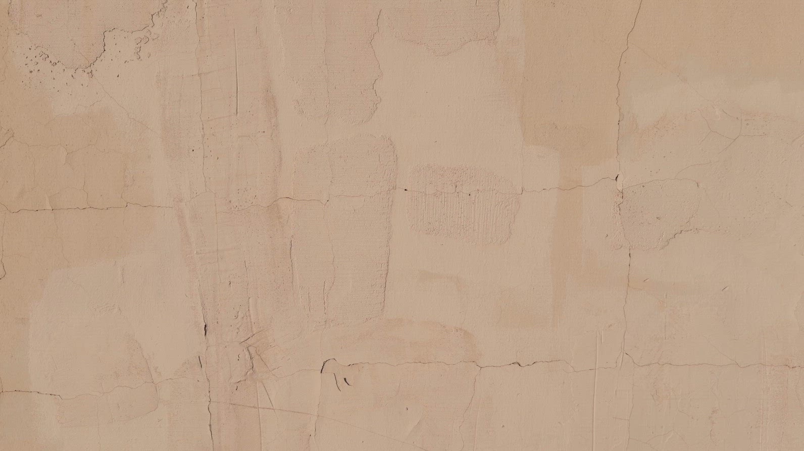A textured beige wall background with subtle cracks