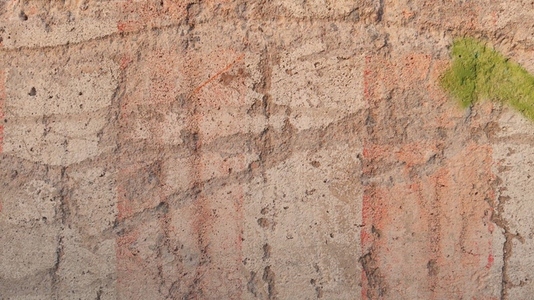 A textured concrete wall background with visible cracks