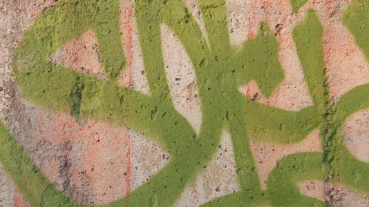 Close up of colorful graffiti on a textured wall background