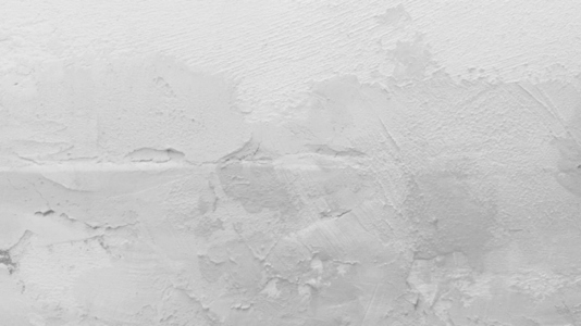 A textured white wall with subtle variations in surface and tone A textured white wall with subtle variations in surface and tone