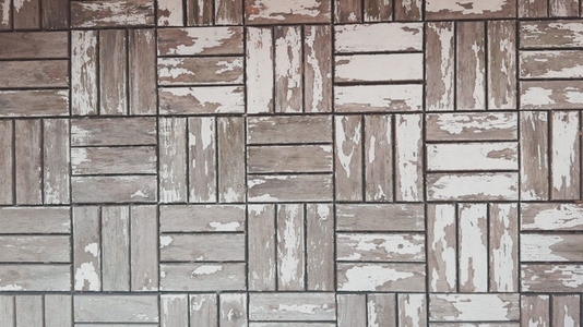 A textured wall background featuring a pattern of weathered wood A textured wall background featuring a pattern of weathered wood