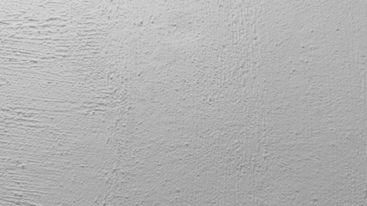 A textured white wall background surface with subtle variations A textured white wall background surface with subtle variations